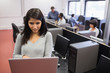 Woman typing on laptop in class