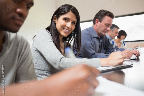 Photo: Woman looking up from lecture Woman looking up from lecture