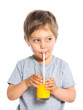 Portrait of little boy drinking orange juice