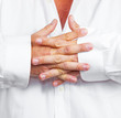 detail of folded hands of a man