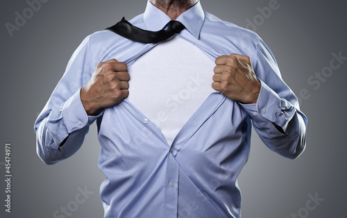 Photo: Superhero, young businessman tearing his shirt off Superhero, young businessman tearing his shirt off