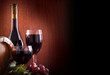 Red wine glass and Bottle on a wooden background
