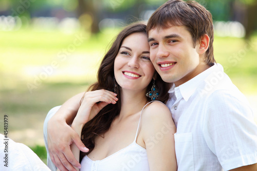 Photo: Young love Couple smiling under blue sky Young love Couple smiling under blue sky