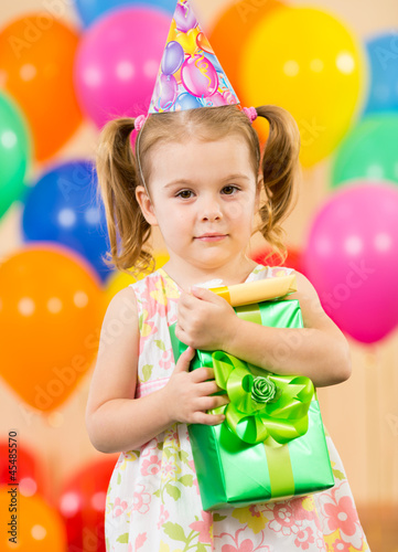 Photo: girl with colorful balloons and gift girl with colorful balloons and gift