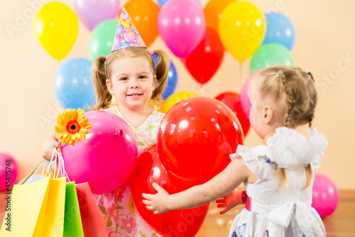 Photo: pretty children with colorful balloons and gifts on birthday par pretty children with colorful balloons and gifts on birthday par