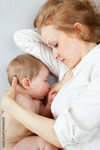 Photo: beautiful mother breast feeding her baby boy beautiful mother breast feeding her baby boy