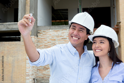 Photo: Couple drawing a house sketch Couple drawing a house sketch