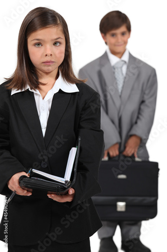 Photo: Little boy and girl dressed in business clothing Little boy and girl dressed in business clothing