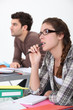 Two students concentrating in class
