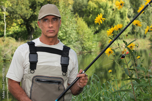 Photo: Fisherman on the edge of river Fisherman on the edge of river