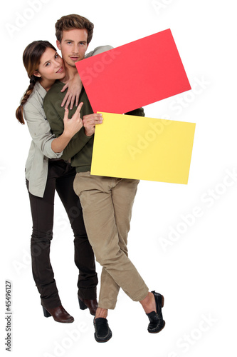 Photo: Couple with red and yellow blank cards Couple with red and yellow blank cards