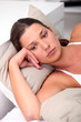 Brunette woman lying in bed
