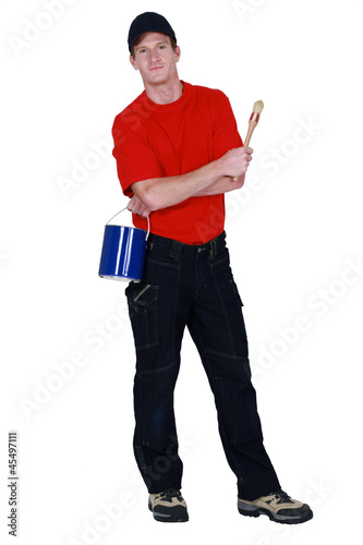 Photo: DIY enthusiast with paint can and brush DIY enthusiast with paint can and brush