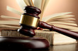 wooden gavel and books on wooden table,on brown background