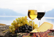 Two wineglasses, cheese and grapes on the terrace of vineyard in