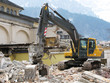 Excavator demolishing an old building