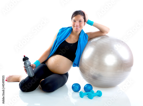 Photo: Beautiful pregnant woman at fitness gym relaxed Beautiful pregnant woman at fitness gym relaxed