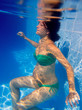 Beautiful pregnant woman underwater blue pool