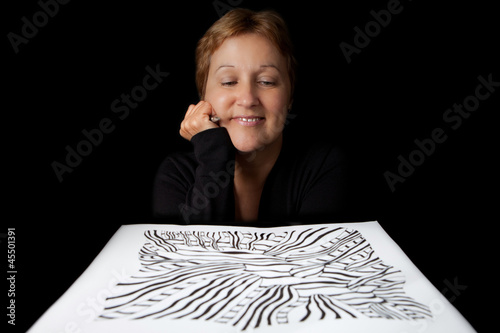 Photo: Artist admiring her work Artist admiring her work