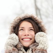Winter woman looking up happy and smiling