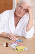 Senior woman in bathrobe about to take drugs
