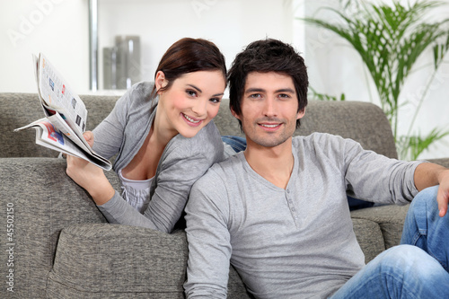 Photo: Couple relaxing in their living room Couple relaxing in their living room