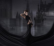 Fashion shoot of a woman in a long dress on a spooky background