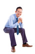 Photo: Asian man sitting on transparent chair Asian man sitting on transparent chair