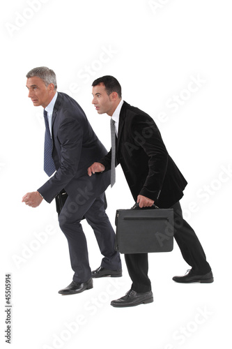 Photo: Businessmen about to start foot race Businessmen about to start foot race