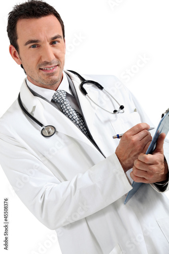 Photo: Doctor writing on clipboard smiling Doctor writing on clipboard smiling