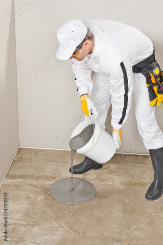 Photo: worker apply self leveling floor worker apply self leveling floor