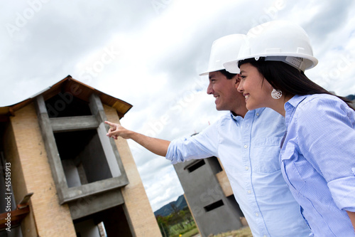 Photo: Civil engineers pointing at a house Civil engineers pointing at a house