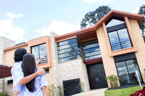 Photo: Couple looking at a house Couple looking at a house