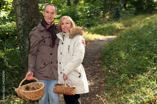 Photo: Couple with basket of chestnuts and mushrooms Couple with basket of chestnuts and mushrooms