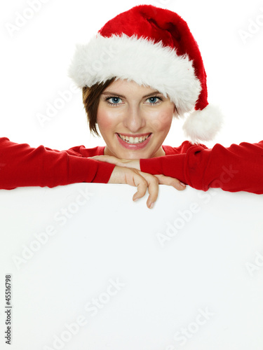 Photo: Women with santa hat presenting white message board Women with santa hat presenting white message board
