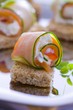 Courgette and salmon rolls with goats cheese on bread