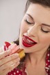 A girl eating a strawberry muffin