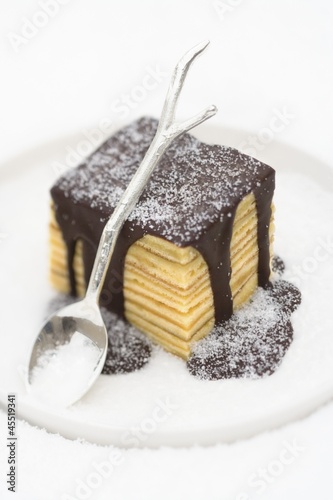 Photo: Baumkuchen (German layer cake) with chocolate sauce and sugar Baumkuchen (German layer cake) with chocolate sauce and sugar