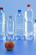 Foto: An Elstar apple and various bottles of mineral water An Elstar apple and various bottles of mineral water