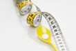Pills on a spoon with a measuring tape