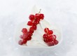 Yogurt ice cream garnished with redcurrants