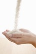 Raw sugar flowing into hands