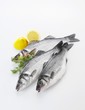 Three fresh sea bass, lemons and dill
