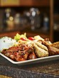 A chicken platter with dips and vegetables