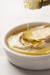Olive oil being pored over hummus