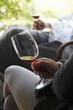 Two people holding glasses of wine