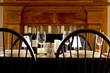 Laid table with red wine in front of fireplace