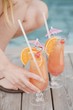 Woman with Planter's Punch by pool