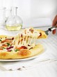 Serving a Piece of Cheesy Pizza Topped with Shrimp and Veggies