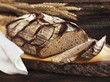 A rustic country loaf on a slice of wood